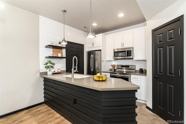 kitchen with open shelves, a sink, white cabinets, a peninsula, and stainless steel appliances