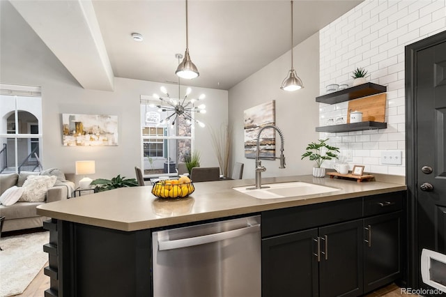 kitchen with open shelves, a sink, dishwasher, open floor plan, and tasteful backsplash