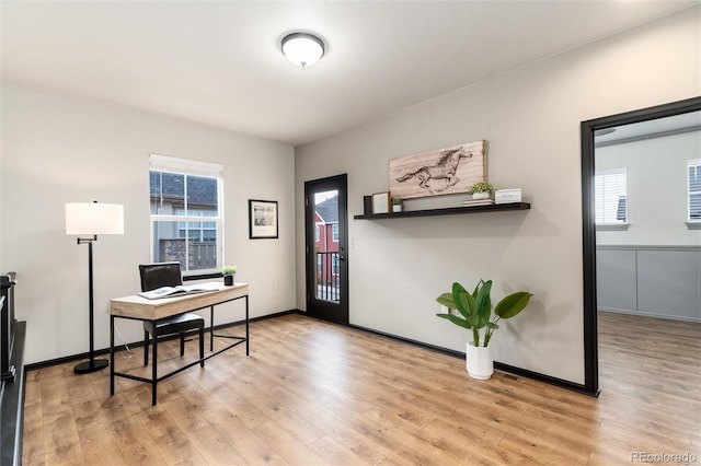 office featuring baseboards, plenty of natural light, and wood finished floors