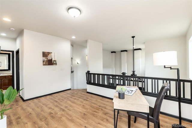 hall featuring recessed lighting, baseboards, an upstairs landing, and light wood finished floors