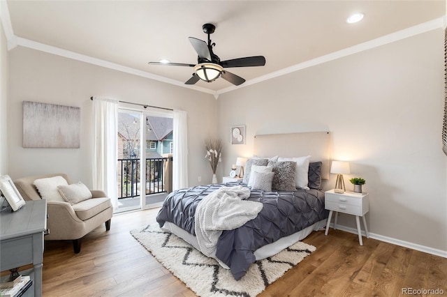 bedroom with baseboards, ornamental molding, wood finished floors, and access to exterior