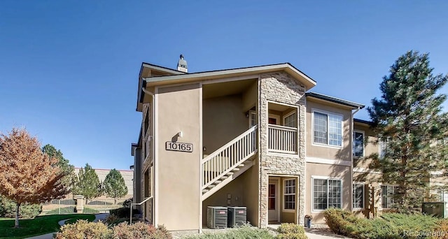 10165 E Carolina Pl Unit 102, Aurora, CO 80247 - view of property with stairway and central air condition unit