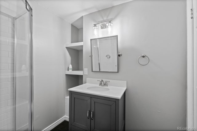 bathroom featuring a stall shower and vanity