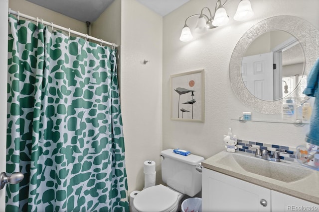 bathroom with toilet, vanity, a shower with curtain, and a textured wall