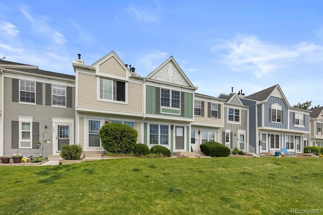 view of property featuring a front yard and entry steps