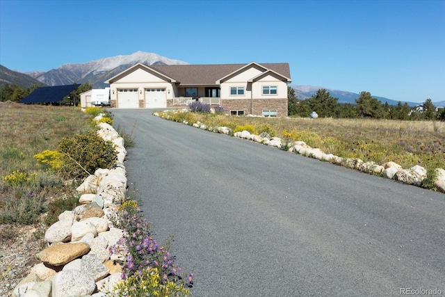 view of front of house featuring a mountain view and a garage