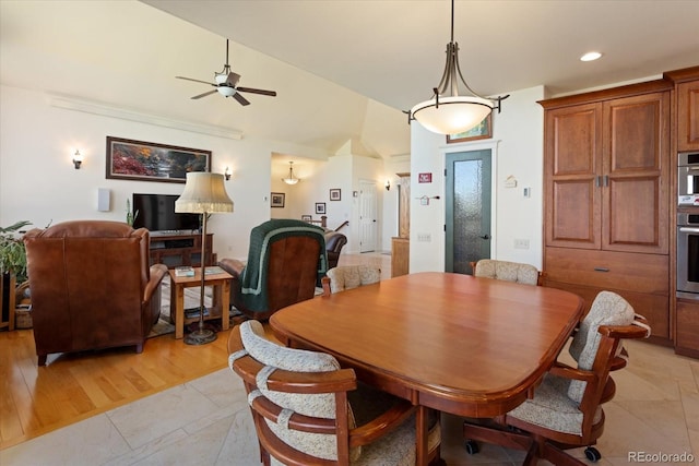 dining space featuring light wood-type flooring, lofted ceiling, and ceiling fan