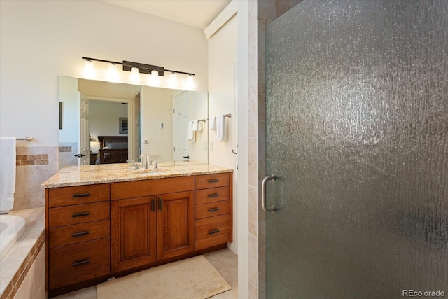 bathroom featuring shower with separate bathtub, tile patterned flooring, vanity, and tile walls