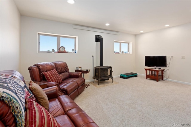 carpeted living room with a wood stove