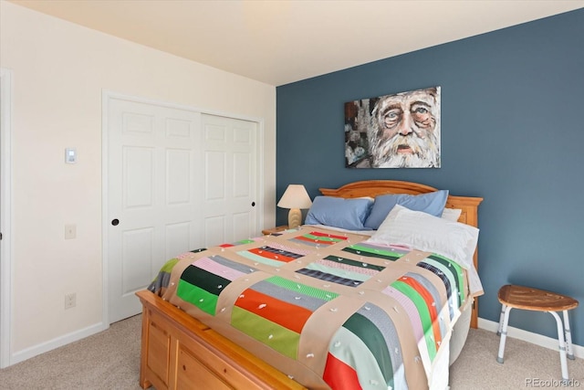 bedroom with light carpet and a closet