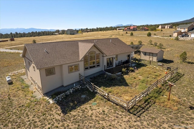 drone / aerial view featuring a mountain view and a rural view