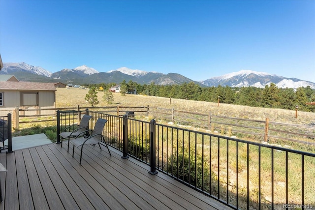 wooden deck with a mountain view and a rural view