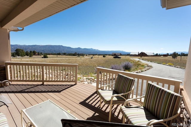 wooden deck featuring a mountain view and a rural view