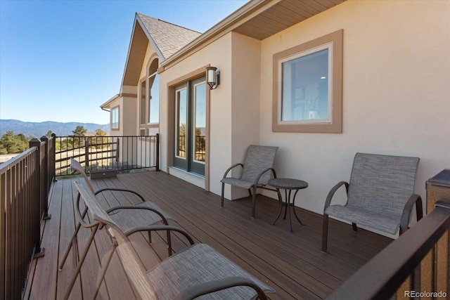 wooden deck with a mountain view