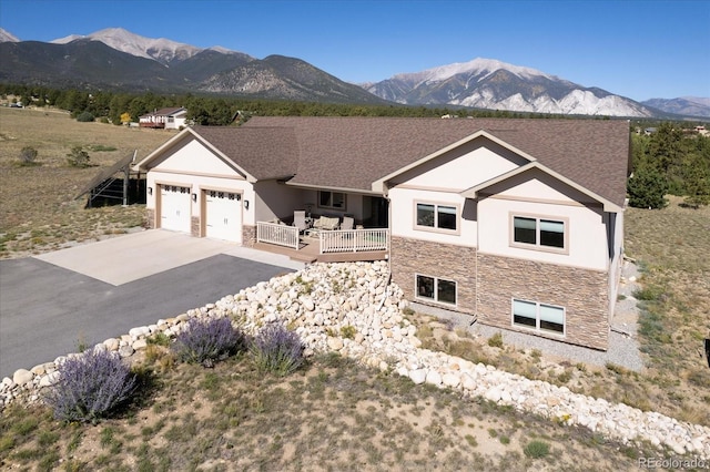 ranch-style home with a mountain view and a garage