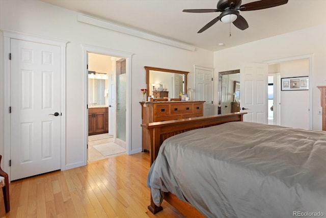 bedroom with light hardwood / wood-style floors, connected bathroom, and ceiling fan