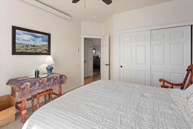 carpeted bedroom with ceiling fan and a closet