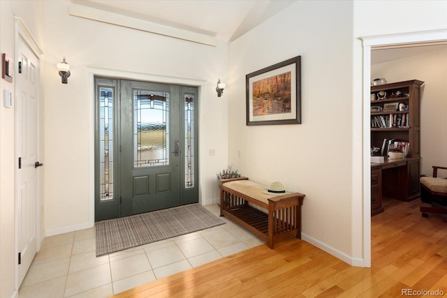 foyer with lofted ceiling and light hardwood / wood-style floors