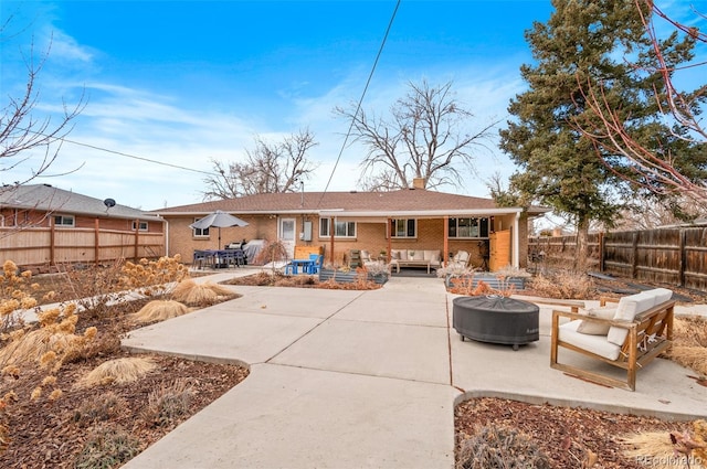 back of property featuring a patio and outdoor lounge area