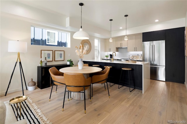 4823 W 10th Ave, Denver, CO 80204 - dining room featuring light wood-style floors and recessed lighting
