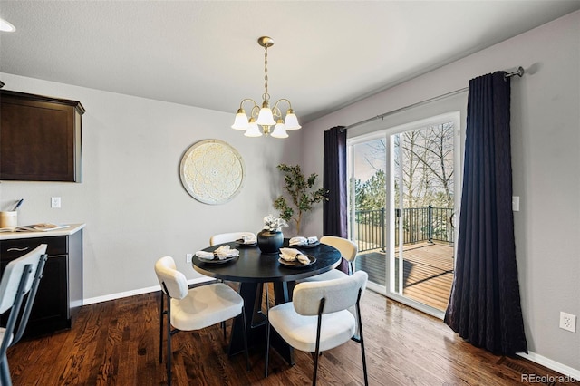 dining room featuring dark wood-type flooring and an inviting chandelier