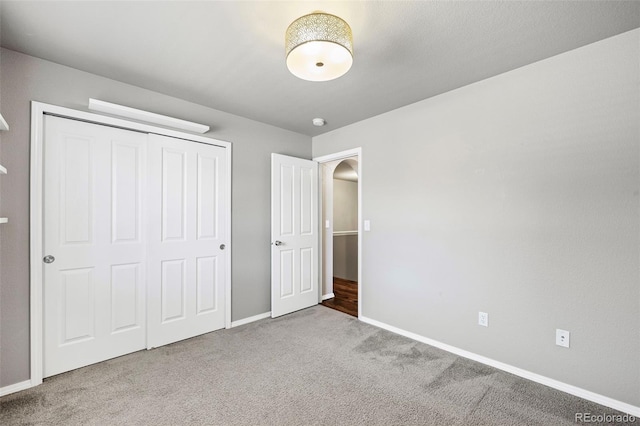 unfurnished bedroom with a closet and carpet flooring