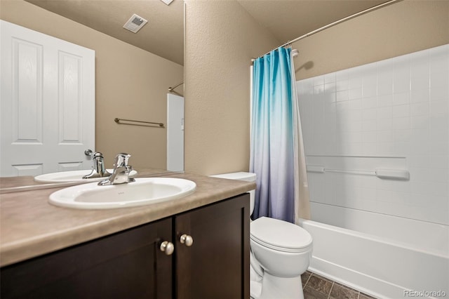 full bathroom with vanity, shower / tub combo with curtain, and toilet