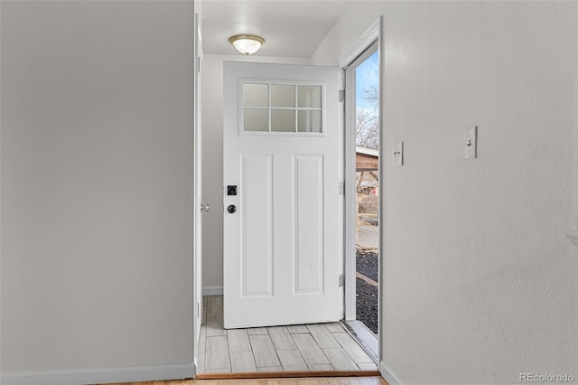 doorway to outside with light wood-type flooring