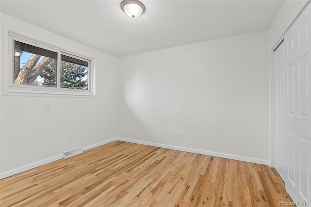 spare room featuring light hardwood / wood-style floors