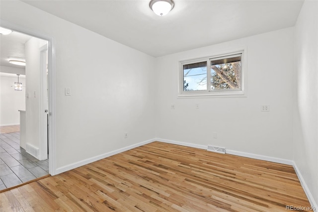 spare room with light hardwood / wood-style flooring