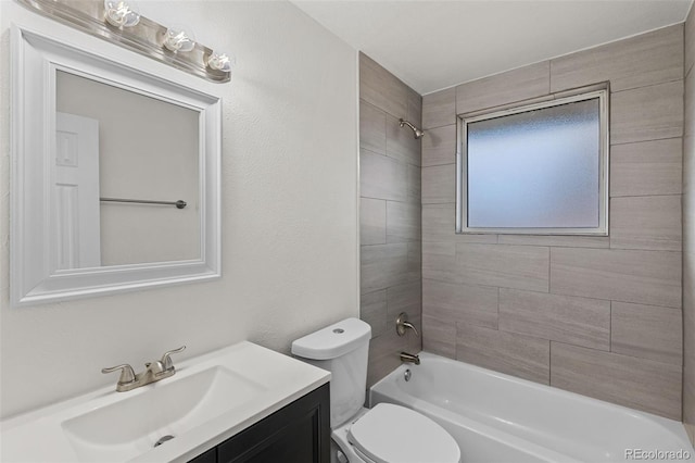 full bathroom with vanity, toilet, and tiled shower / bath combo