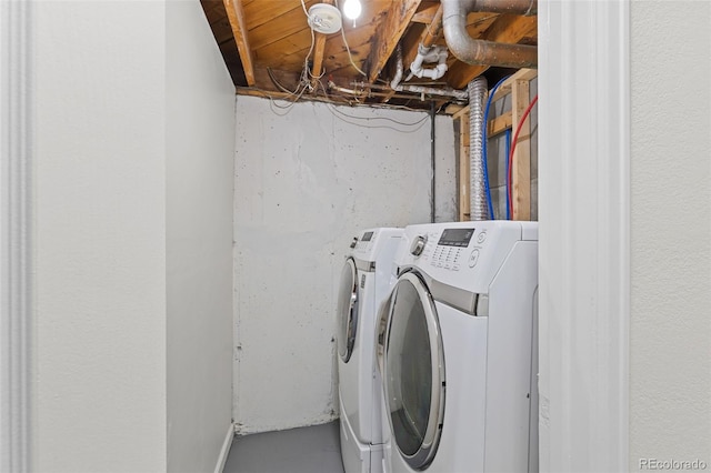 clothes washing area featuring washer and dryer