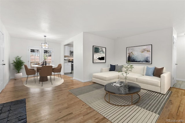 living room featuring light hardwood / wood-style flooring and a chandelier