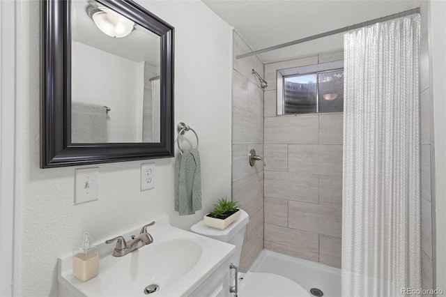 bathroom featuring vanity, a shower with shower curtain, and toilet