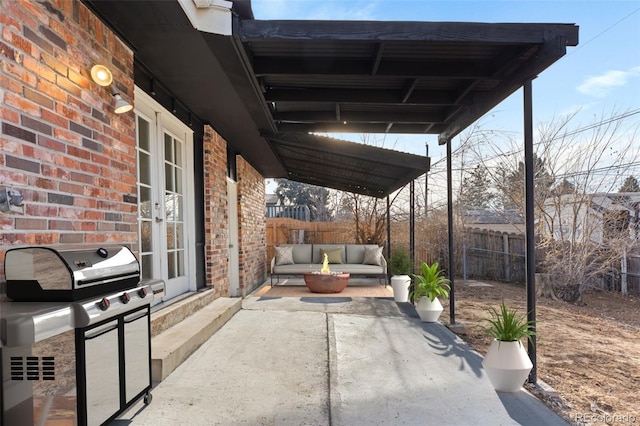 view of patio with outdoor lounge area and a grill