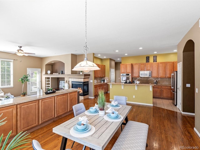 3853 S Malta St, Aurora, CO 80013 - dining area featuring a glass covered fireplace, recessed lighting, light wood-style floors, and a ceiling fan