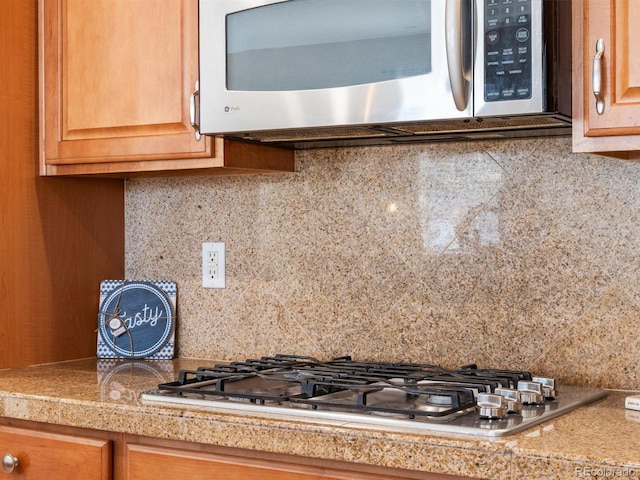 3853 S Malta St, Aurora, CO 80013 - kitchen view of appliances with stainless steel finishes, tile counters, and backsplash