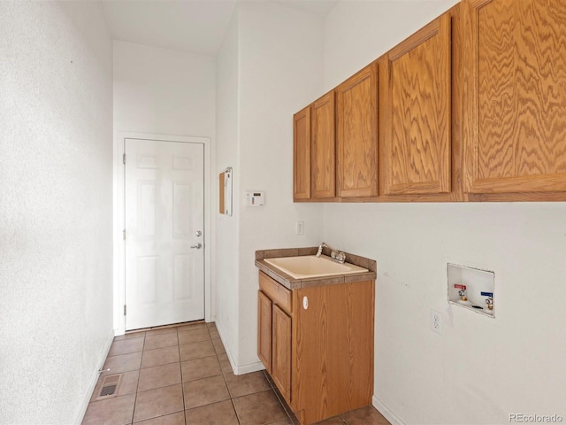 3853 S Malta St, Aurora, CO 80013 - laundry area with hookup for a washing machine, cabinet space, light tile patterned flooring, and baseboards