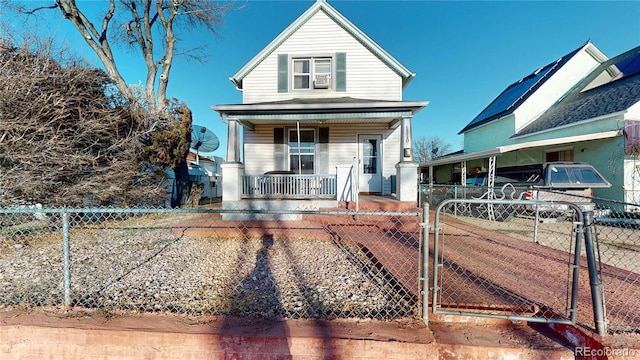 view of front of house featuring a fenced front yard, covered porch, and a gate