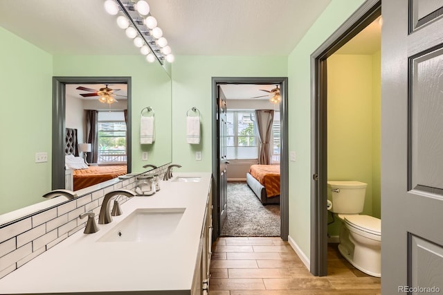 1727 N Pearl St Unit 107, Denver, CO 80203 - bathroom with ensuite bath, double vanity, ceiling fan, and toilet