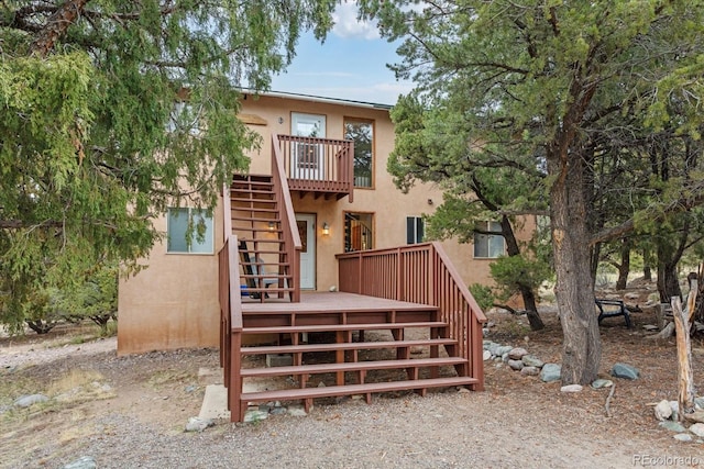 4236 Tranquil Way, Crestone, CO 81131 - rear view of house featuring a deck, stucco siding, and stairway