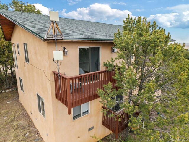 4236 Tranquil Way, Crestone, CO 81131 - rear view of house with a deck, a shingled roof, and stucco siding