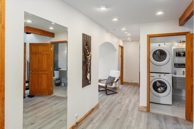 4236 Tranquil Way, Crestone, CO 81131 - laundry area with stacked washer and dryer, laundry area, baseboards, and light wood finished floors