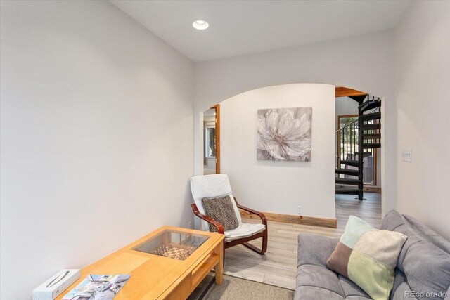 4236 Tranquil Way, Crestone, CO 81131 - living area featuring stairs, arched walkways, recessed lighting, and light wood-style flooring