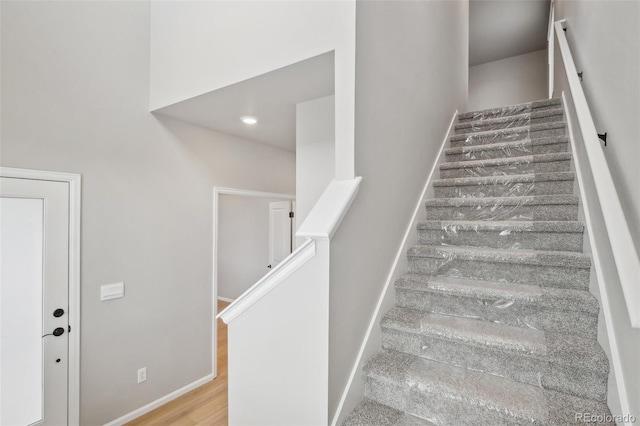 stairway with hardwood / wood-style floors