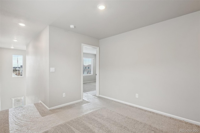 empty room with light colored carpet