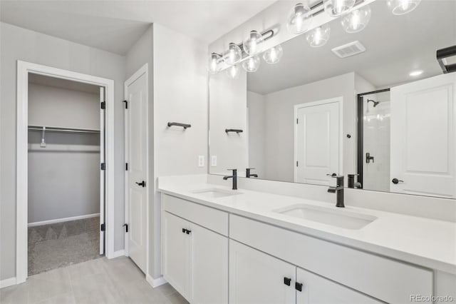 bathroom with tile patterned flooring, vanity, and an enclosed shower