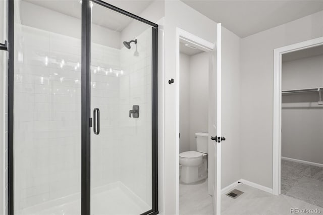 bathroom with walk in shower and toilet