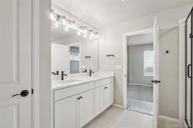 bathroom with tile patterned flooring, vanity, and an enclosed shower