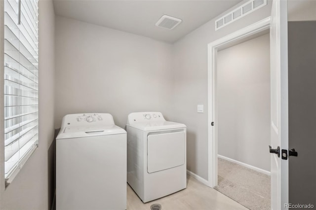 clothes washing area featuring washing machine and dryer